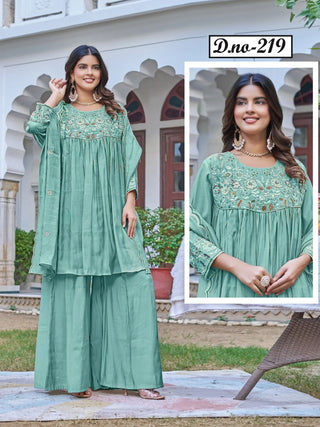 A woman modeling a mint green traditional Indian outfit with a matching embroidered kurta and wide-leg pants, standing outdoors in front of a white building with arches. An inset close-up of the kurta's embroidered neckline is shown on the right, with the text 'D-no-219' at the top.
